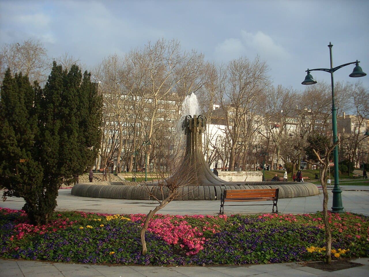 Fountain, flower beds and plane trees in Gezi Park beside Taksim Square
